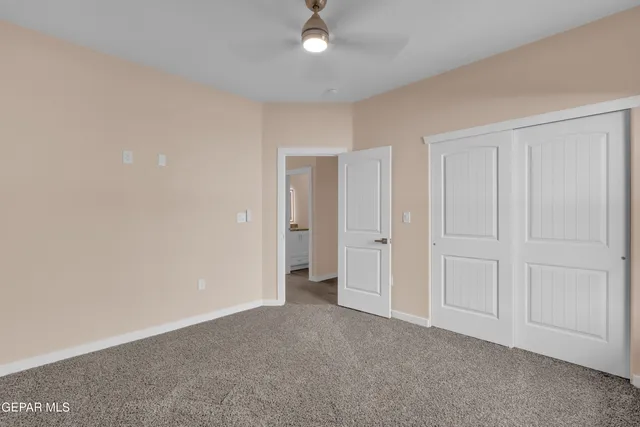 a view of an empty room and closet area