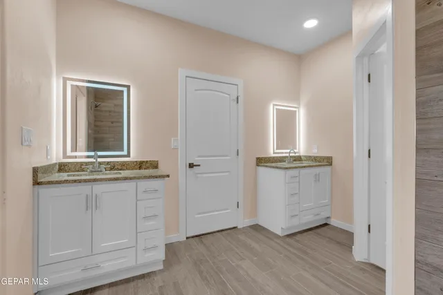 a view of a kitchen with granite countertop cabinets and wooden floor