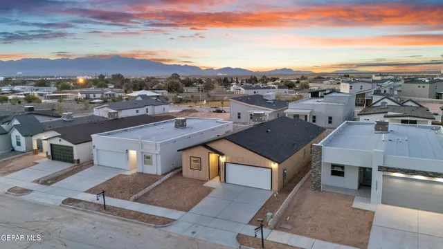 an aerial view of a houses with a city street