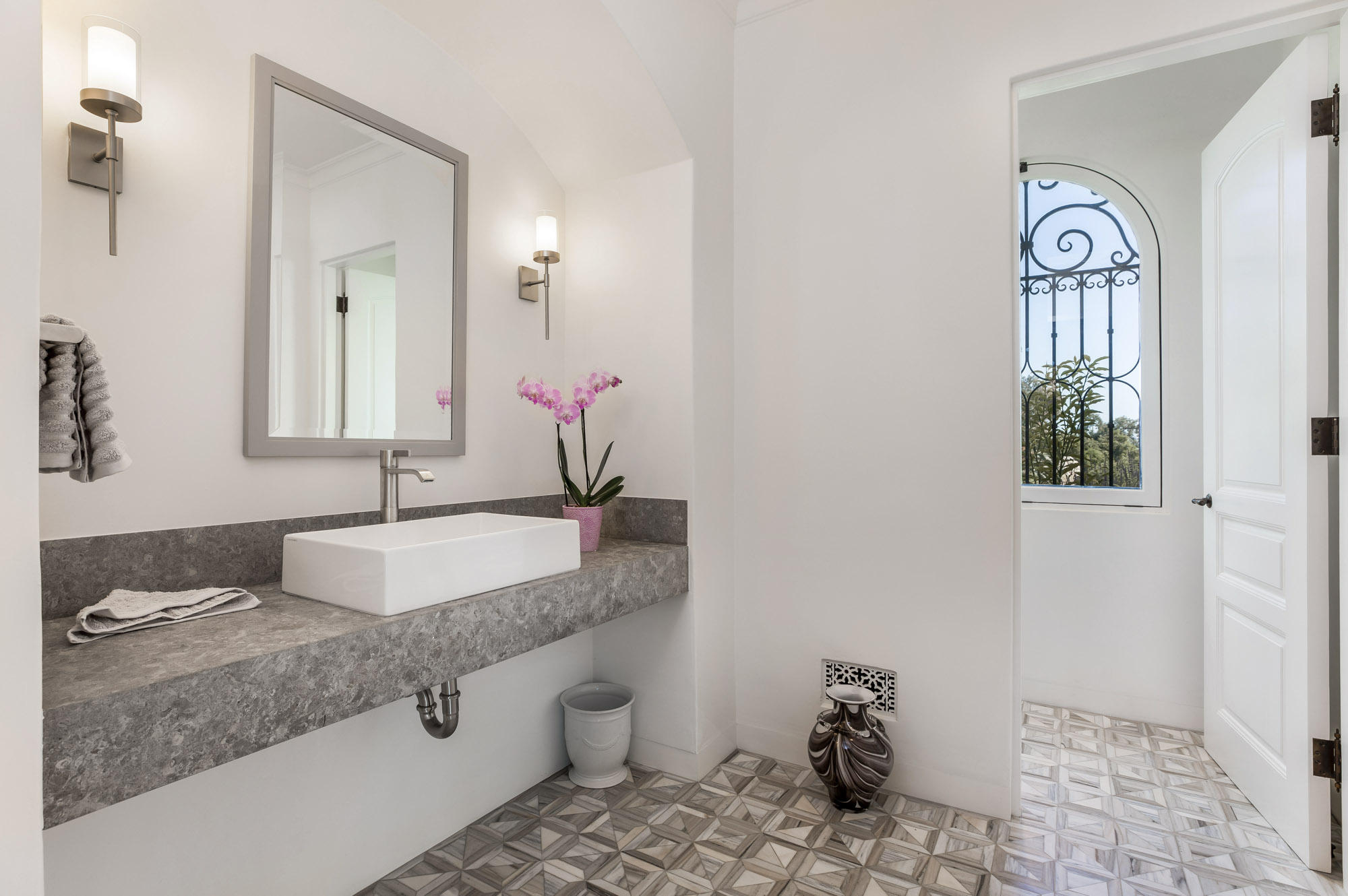 1084 Golf Road Montecito, CA 93108 - Photo 12 of 47 a bathroom with a granite countertop sink a mirror and a toilet