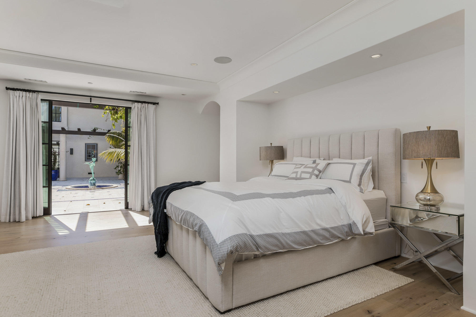 1084 Golf Road Montecito, CA 93108 - Photo 15 of 47 a spacious bedroom with a bed and lamp