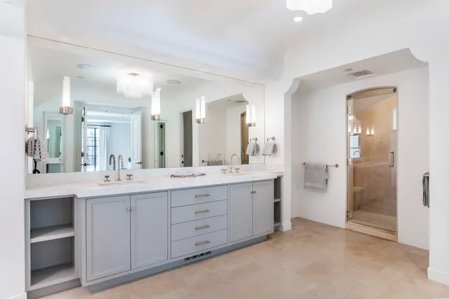 a bathroom with a double vanity sink mirror and double