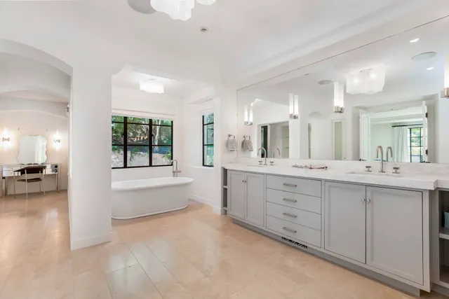 a large bathroom with a large tub and sink