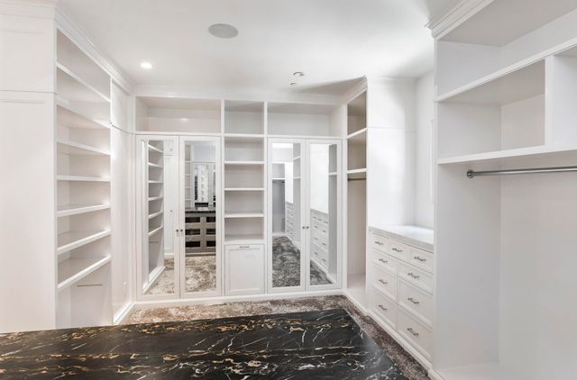 a view of a bedroom with wooden floor and windows