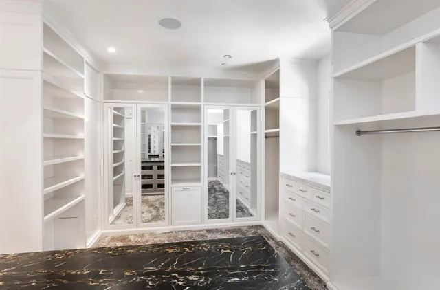 a view of a bedroom with wooden floor and windows