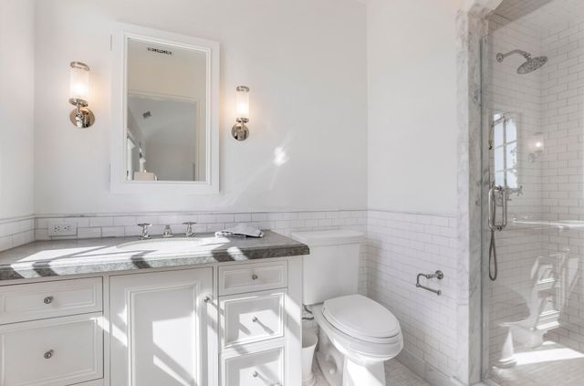 a bathroom with a sink toilet and shower