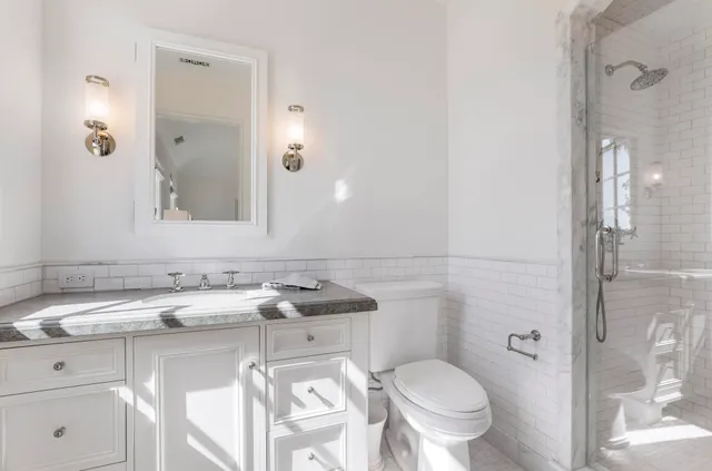 a bathroom with a sink toilet and shower