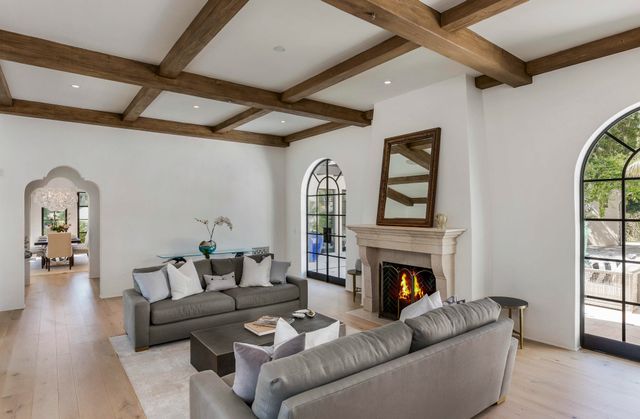 a living room with furniture a window and a fireplace