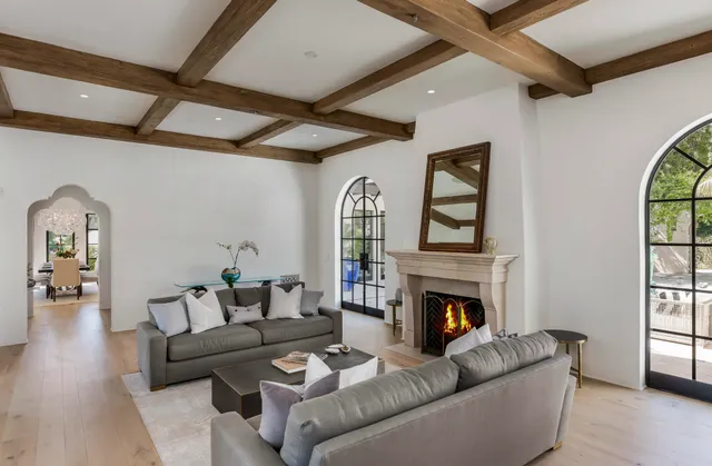 a living room with furniture a window and a fireplace