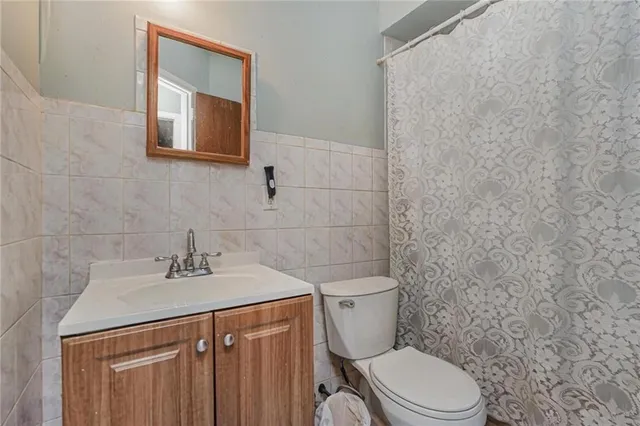 a bathroom with a sink a toilet and mirror