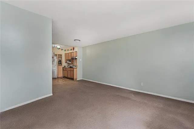 an empty room with closet and windows