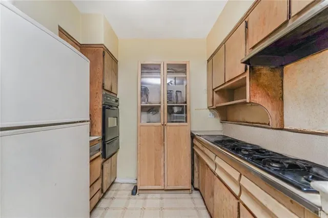 a kitchen with a sink stove and refrigerator