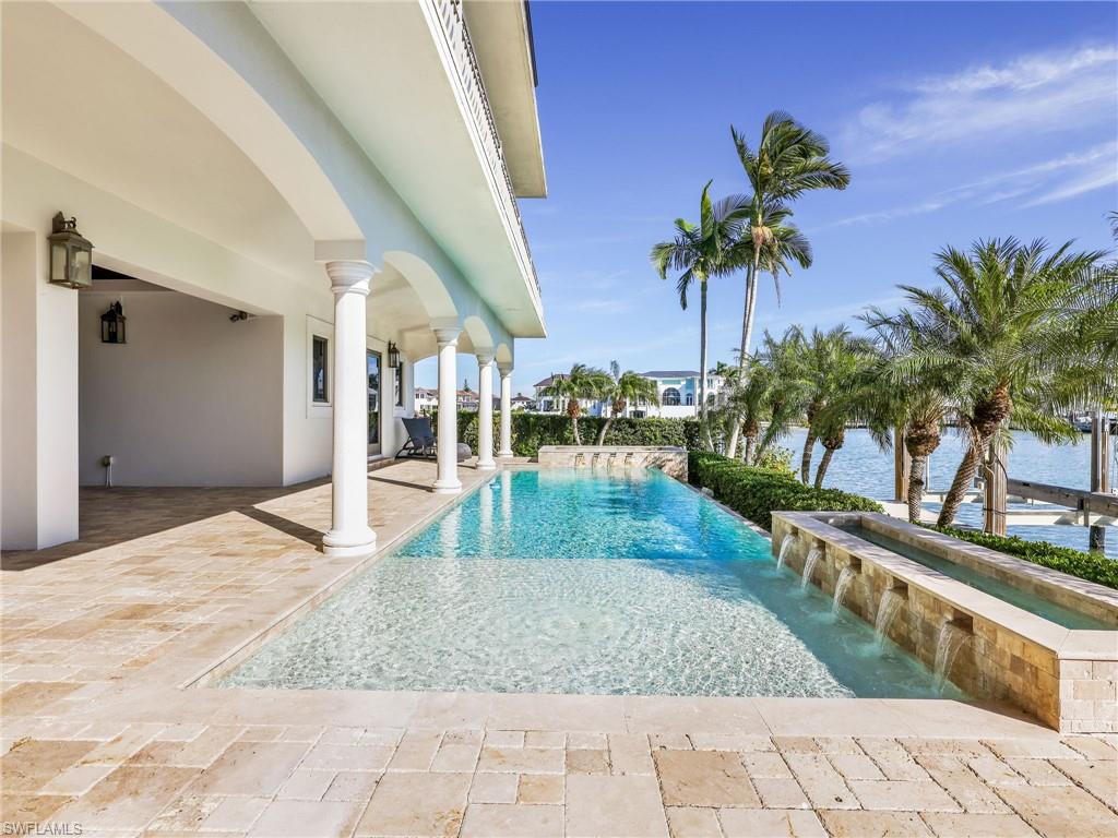 264 Bayview Avenue Naples, FL 34108 - Photo 11 of 50 a view of a swimming pool with lounge chair