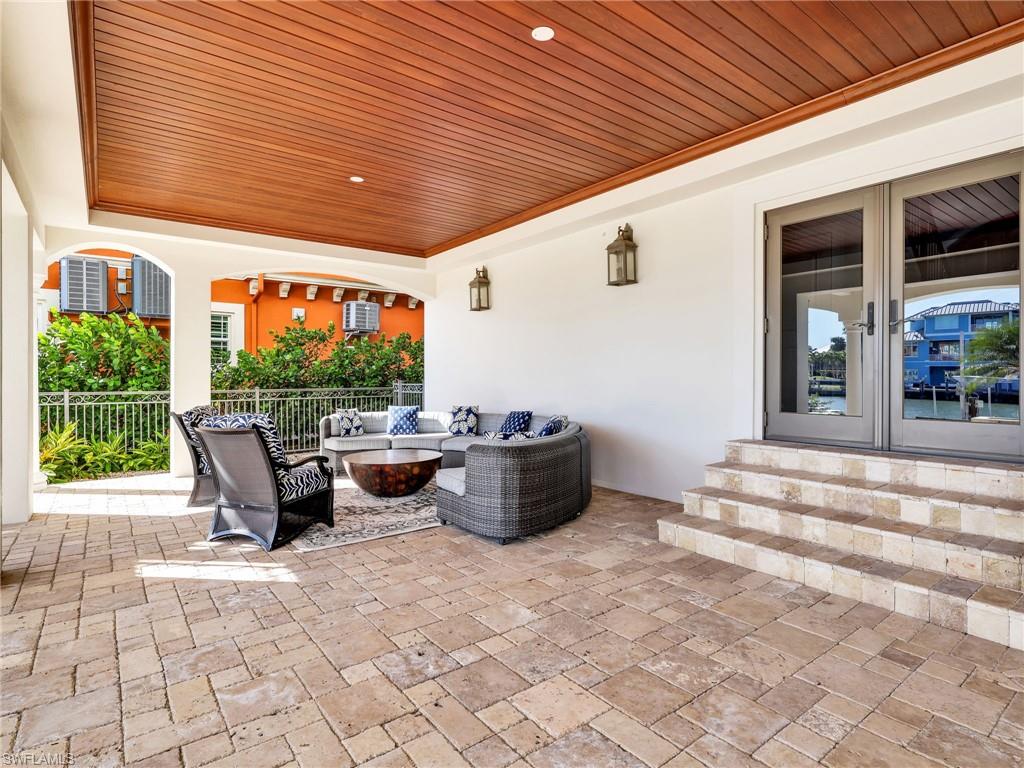 264 Bayview Avenue Naples, FL 34108 - Photo 13 of 50 a view of a patio with table and chairs