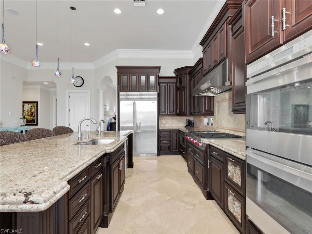 264 Bayview Avenue Naples, FL 34108 - Photo 19 of 50 a large kitchen with granite countertop a sink and a stove
