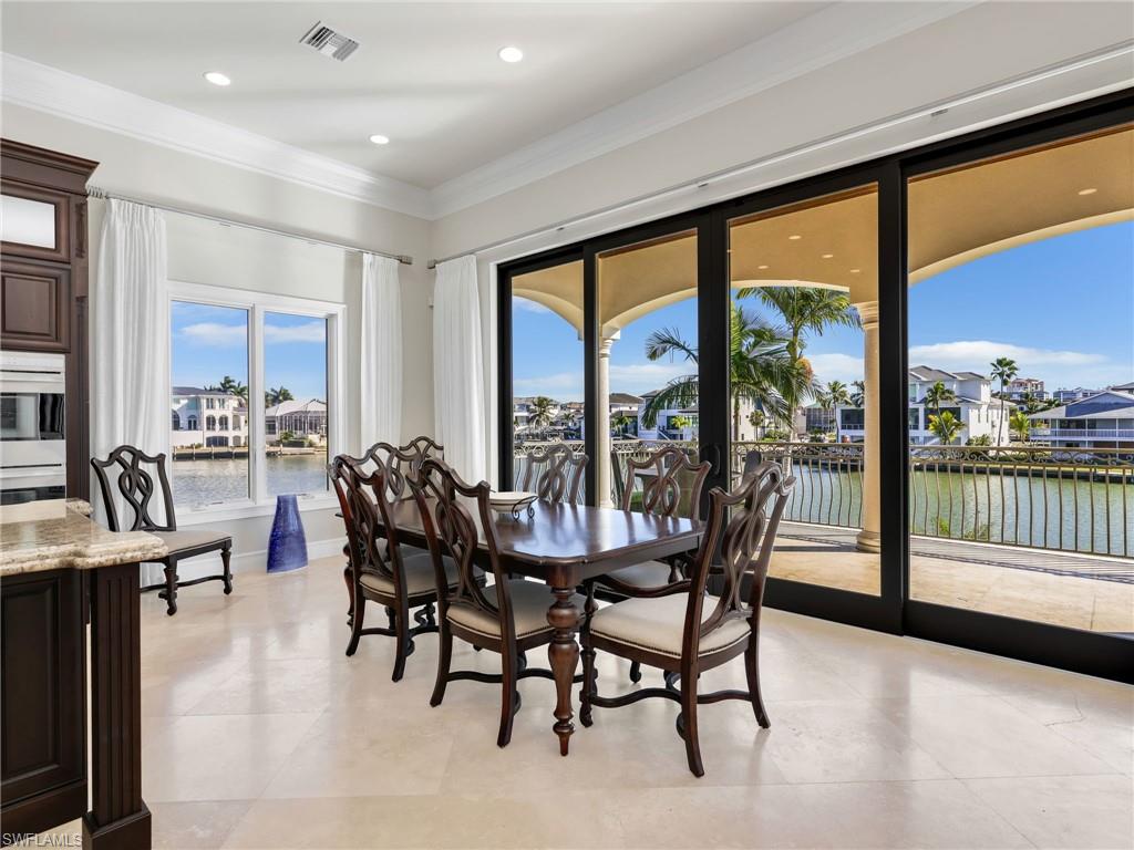 264 Bayview Avenue Naples, FL 34108 - Photo 21 of 50 a dining room with furniture water view and a floor to ceiling window