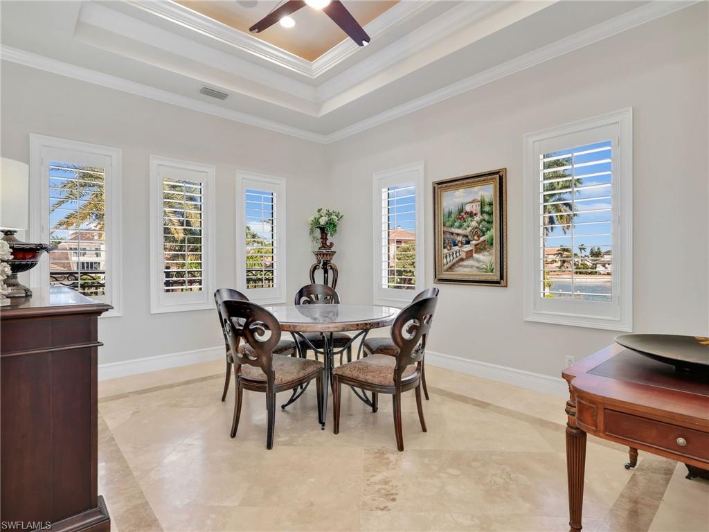 264 Bayview Avenue Naples, FL 34108 - Photo 24 of 50 a view of a dining room with furniture and wooden floor