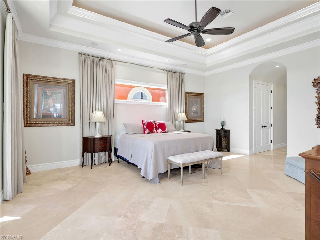 264 Bayview Avenue Naples, FL 34108 - Photo 26 of 50 a bed room with a bed and a chandelier