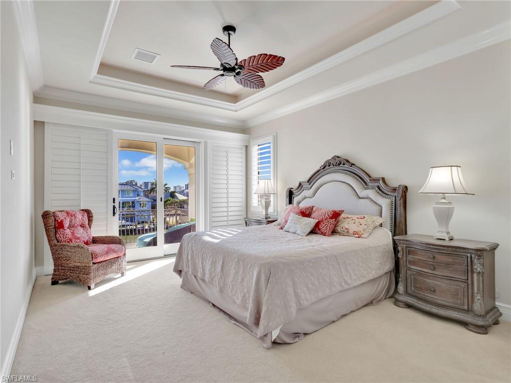 264 Bayview Avenue Naples, FL 34108 - Photo 35 of 50 a bedroom with a bed and a chandelier