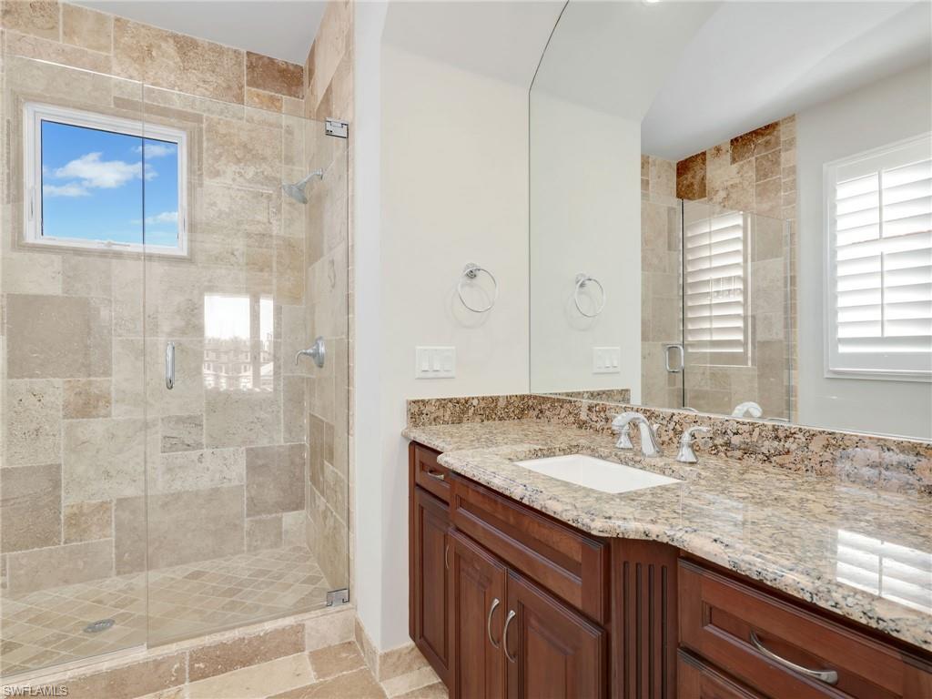 264 Bayview Avenue Naples, FL 34108 - Photo 36 of 50 a bathroom with a granite countertop sink a shower and a mirror