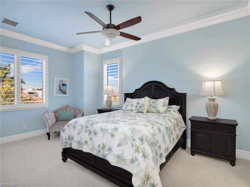 264 Bayview Avenue Naples, FL 34108 - Photo 39 of 50 a bedroom with a bed chandelier and a window