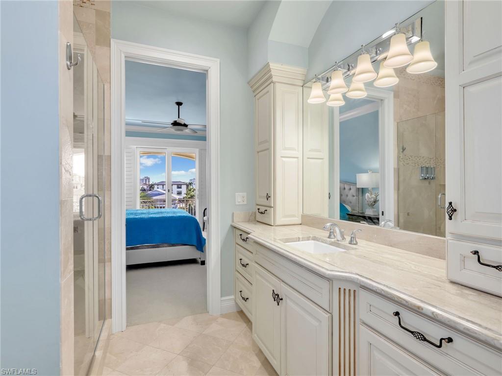264 Bayview Avenue Naples, FL 34108 - Photo 40 of 50 a en suite bathroom with a double vanity sink and a mirror