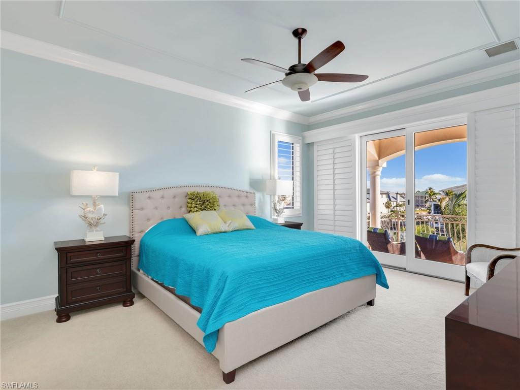 264 Bayview Avenue Naples, FL 34108 - Photo 41 of 50 a bedroom with a bed a ceiling fan and a large window
