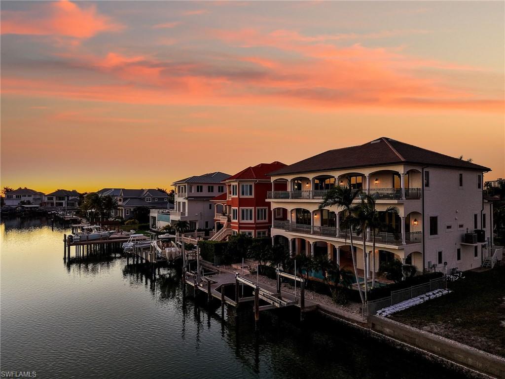264 Bayview Avenue Naples, FL 34108 - Photo 49 of 50 a view of a lake with building in front of it