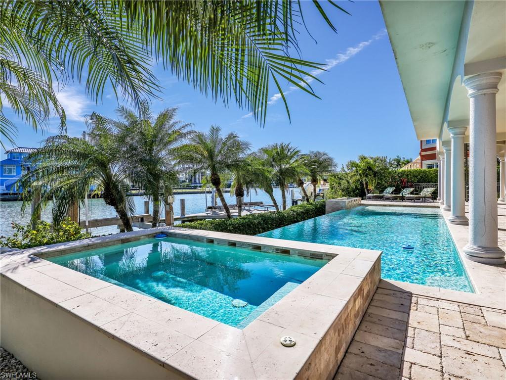 264 Bayview Avenue Naples, FL 34108 - Photo 10 of 50 a view of swimming pool with a table and chairs