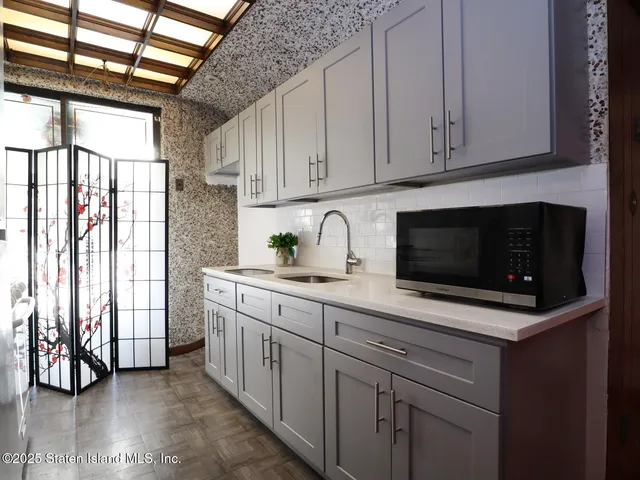 a kitchen with stainless steel appliances granite countertop a refrigerator and cabinets