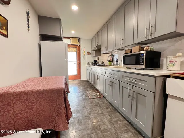 a kitchen with stainless steel appliances kitchen island granite countertop a sink a stove and cabinets