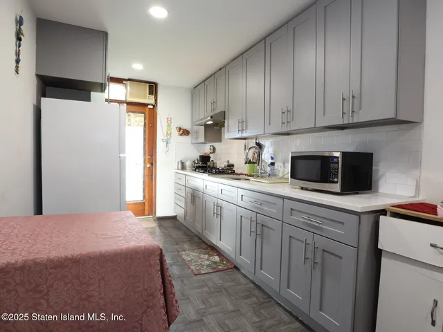 a kitchen with stainless steel appliances granite countertop a refrigerator sink and cabinets