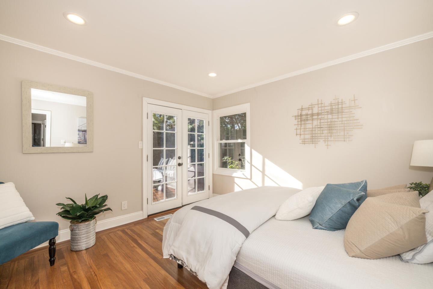 182 Rutherford Avenue Redwood City, CA 94061 - Photo 19 of 34 a bedroom with a large bed and wooden floor