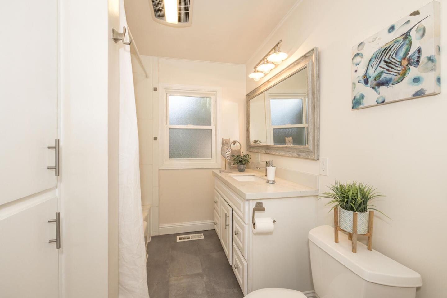 182 Rutherford Avenue Redwood City, CA 94061 - Photo 24 of 34 a bathroom with a sink a toilet and a mirror