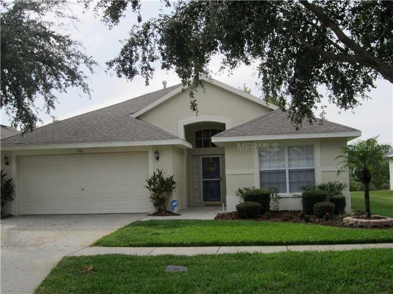 5707 Hawklake Road Lithia, FL 33547 - Photo 1 of 1 a front view of a house with a garden and plants