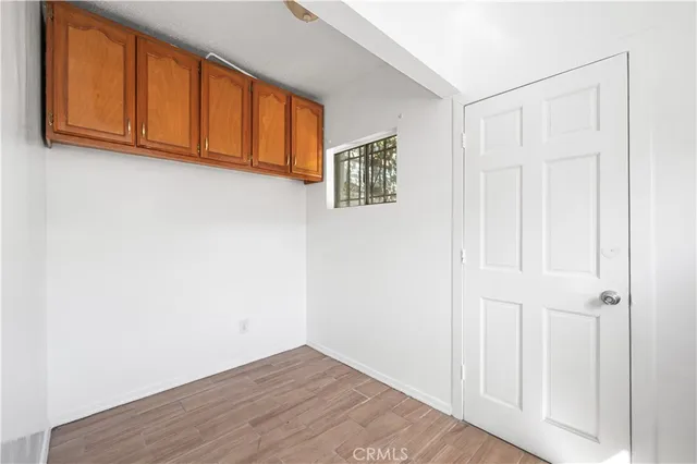 a view of an empty room with wooden floor