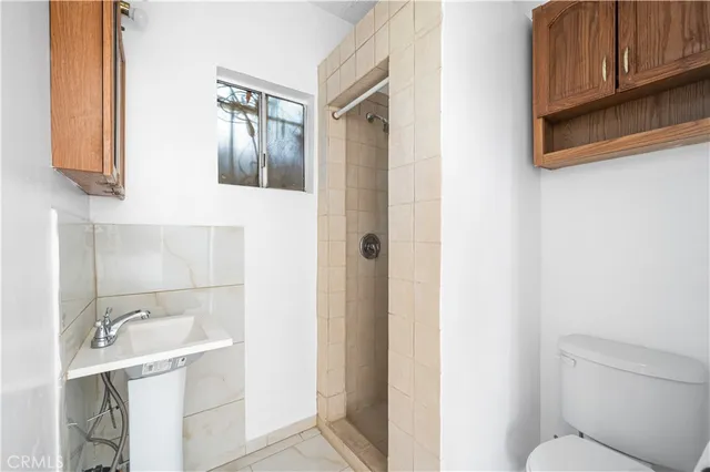 a bathroom with a sink toilet and shower