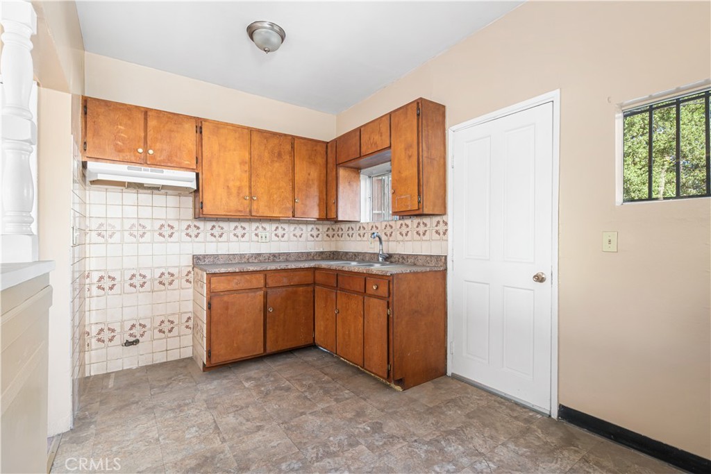 1727 Bellevue Avenue Los Angeles, CA 90026 - Photo 26 of 40 a kitchen with granite countertop a sink cabinets and a window