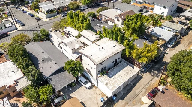 an aerial view of multiple houses with yard
