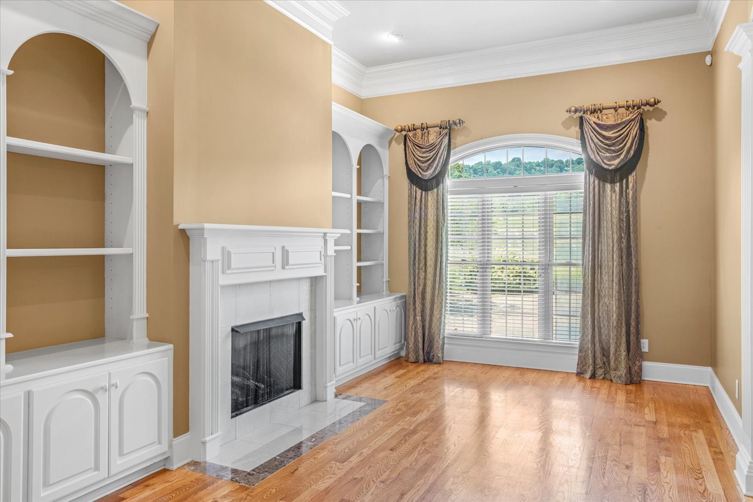 1400 Franklin Road Brentwood, TN 37027 - Photo 11 of 67 a view of an empty room with a fireplace and a window