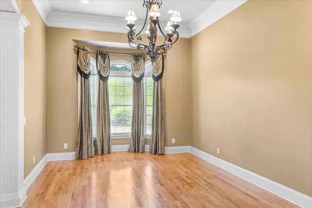 a view of a livingroom with wooden floor and a fireplace