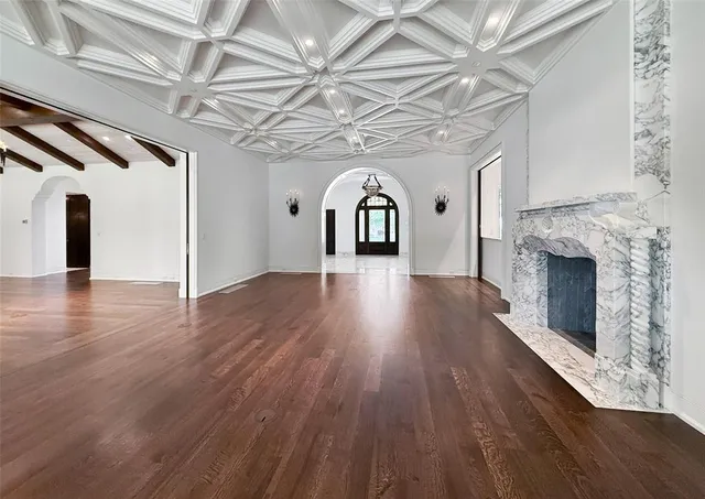 a view of a room with wooden floors and fireplace