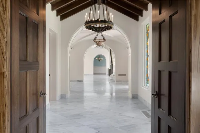 a view of a hallway with a chandelier
