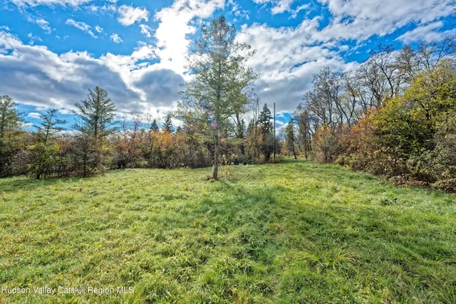 a view of a yard with wooden fence