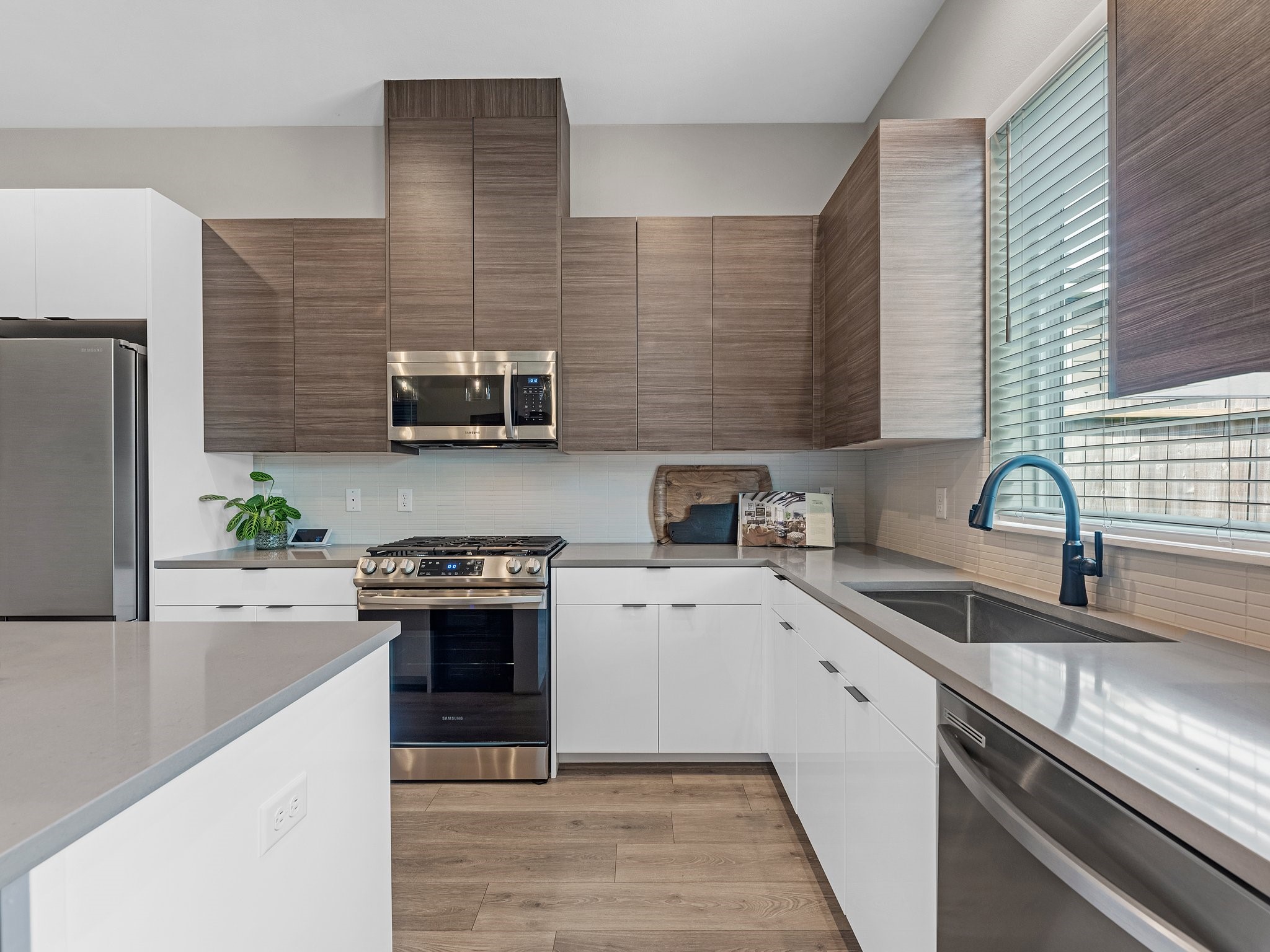 307 Charlock Street Houston, TX 77022 - Photo 3 of 18 a kitchen with stainless steel appliances granite countertop white cabinets a stove top oven a sink and dishwasher
