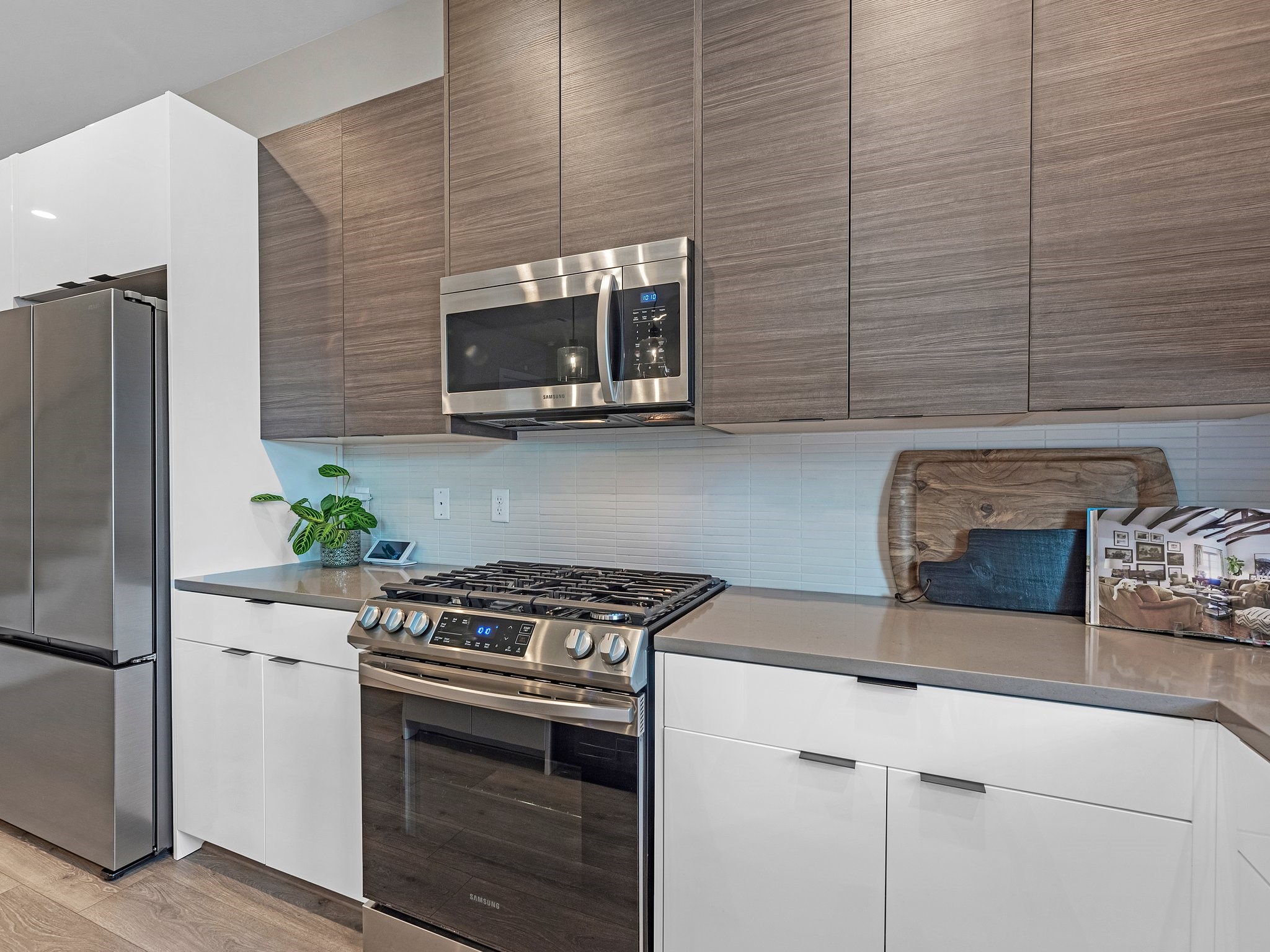 307 Charlock Street Houston, TX 77022 - Photo 4 of 18 a kitchen with stainless steel appliances wooden cabinets stove and microwave