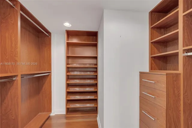 a view of walk in closet with empty racks