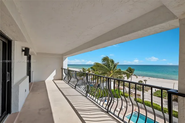 a view of a lake with a palm and lawn chairs