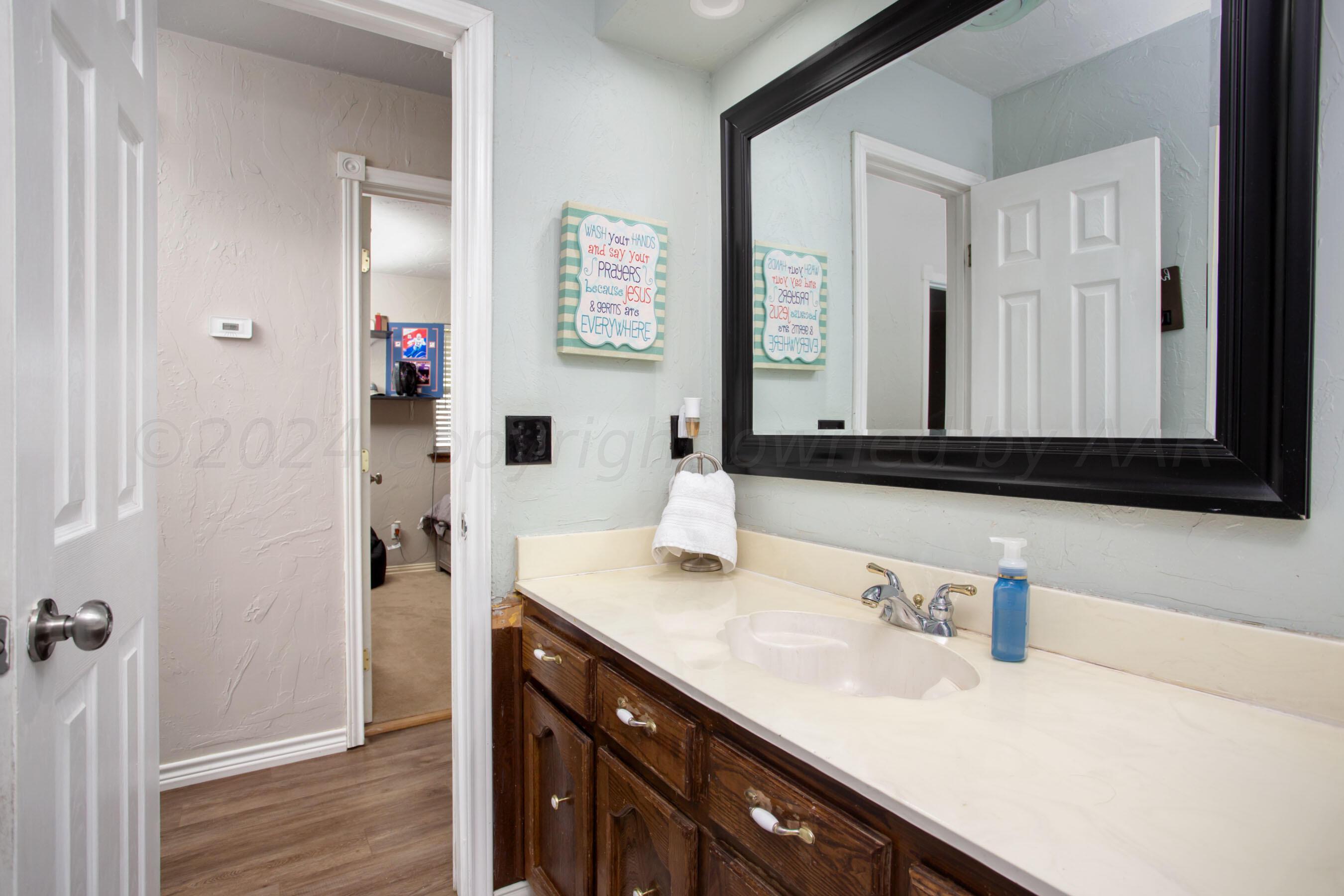 8122 Santa Fe Trail Amarillo, TX 79110 - Photo 11 of 23 a bathroom with a sink and a mirror