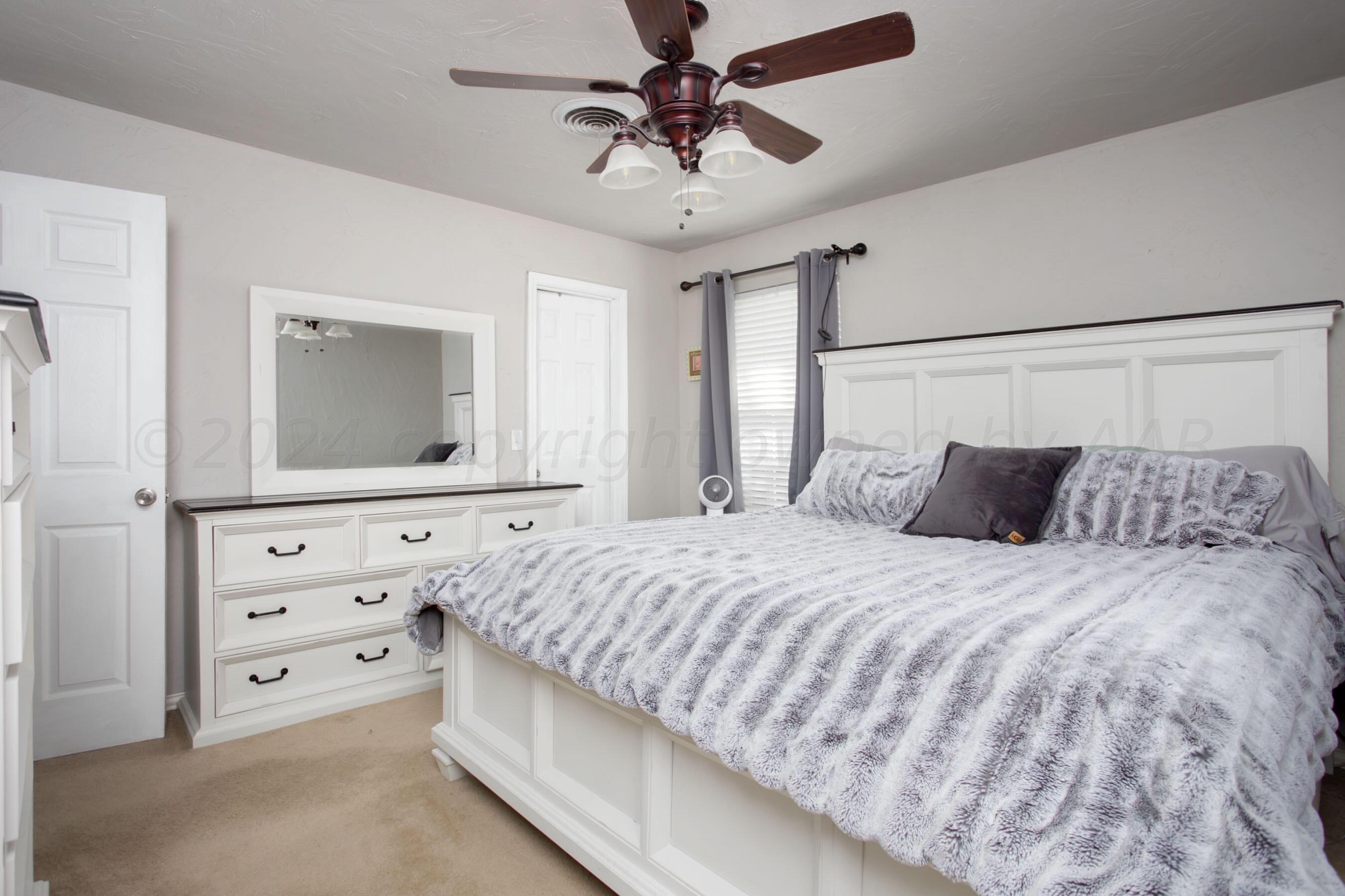 8122 Santa Fe Trail Amarillo, TX 79110 - Photo 15 of 23 a bedroom with a bed and a dresser